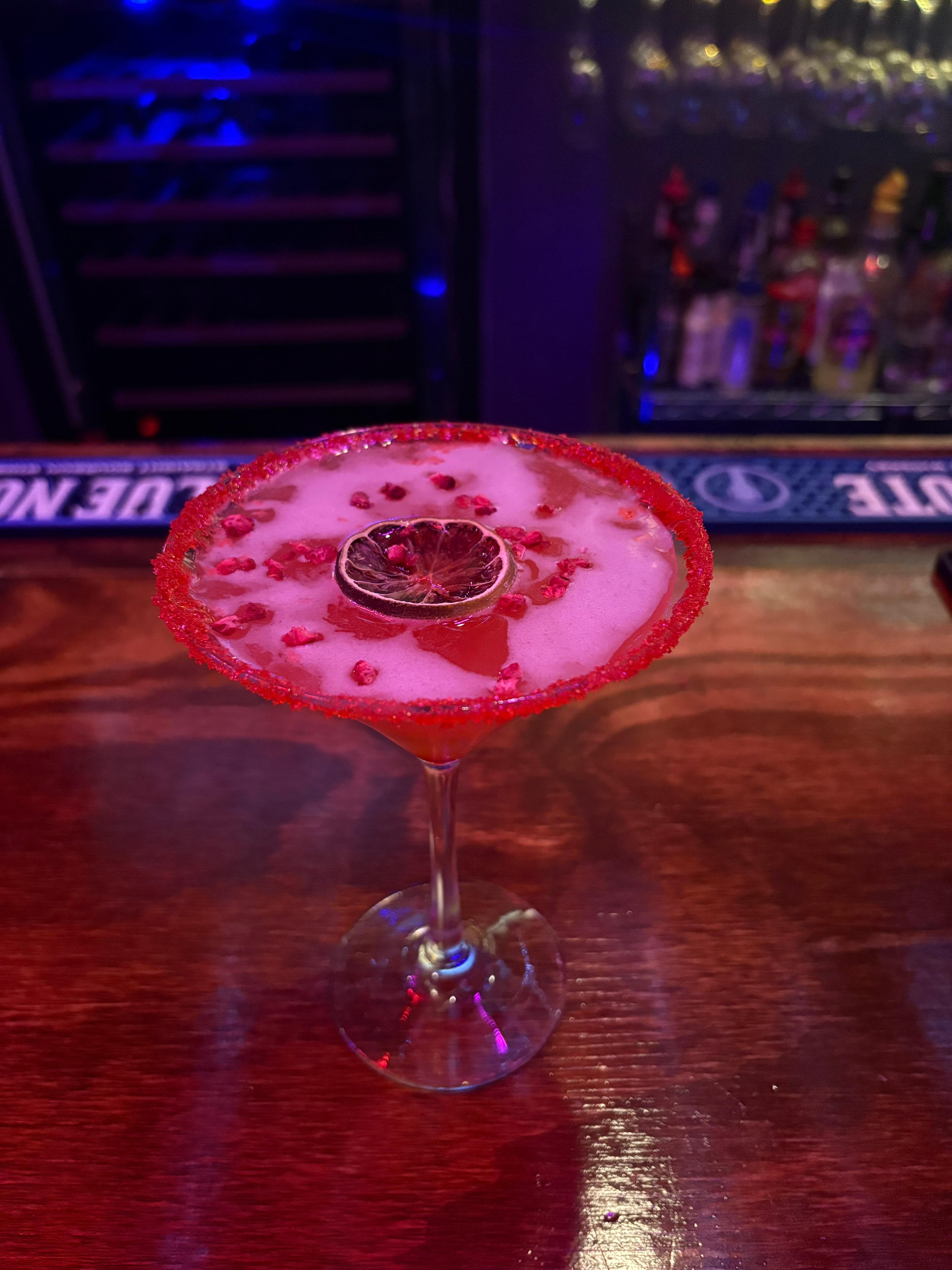 A vivid red signature drink at Intertwine